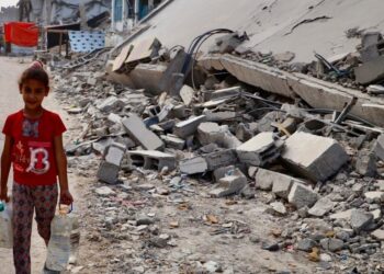 A child walks past ruined buildings in Gaza. Photo: