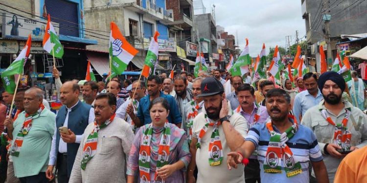 Cong leader Mohinder Bhardwaj leading a rally in Vijaypur on Monday.