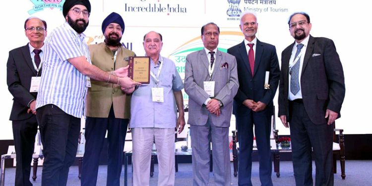 An Asia Greens, Jammu representative receiving an award from HRANI leaders in Greater Noida.