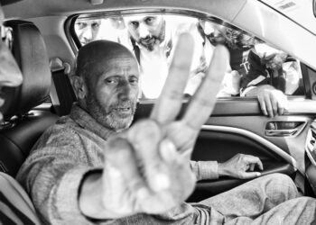 Engineer Rashid flashes the victory sign on the campaign trail.