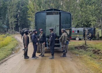 Security personnel stand guard after an encounter broke out between terrorists and security forces during cordon and search operation at Adigam village, in Kulgam district.