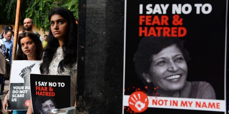 Demonstrators hold placards with the picture of journalist Gauri Lankesh during a 'Not In My Name' protest in New Delhi on September 7, 2017.