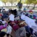 A group of migrants rest on a gazebo at a park after the deportees from the U.S. were pushed by Mexican authorities off an area they had been staying after their expulsion on March 20, 2021