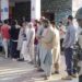 People wait in a queue to cast their votes during the third and final phase of Jammu and Kashmir Assembly elections, at Handwara in Kupwara district