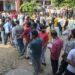 People wait in queues to cast their votes at a polling booth during the third and final phase of Jammu and Kashmir Assembly elections, in Jammu