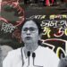 Messages written on the streets say 'can't sell a spine' and 'don't sleep Mamata, the people have risen'. In the foreground is Mamata Banerjee.