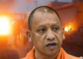 Adityanath. In the background is an image circulating, purportedly of Bahraich during the communal violence there.