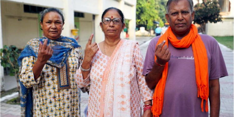 People from the Valmiki community show their fingers marked with indelible ink after casting their votes during the third and final phase of Jammu & Kashmir Assembly elections, at Gandhi Nagar in Jammu