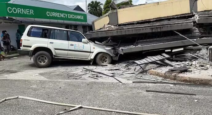 A damaged car trapped underneath a collapsed building in Vanuatu's capital Port Vila after a 7.3-magnitude quake struck on December 17 at a depth of 57 kilometres.