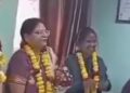 Both the husband and wife (second and second L) were seen wearing garlands and smiling during his farewell at office.