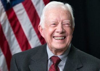 Former US President Jimmy Carter (C) waves after meeting 22 September 1990 in Port-au-Prince with authorities about the upcoming elections in Haiti. (AFP/File)(AFP)