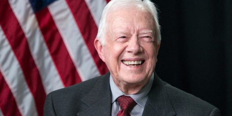 Former US President Jimmy Carter (C) waves after meeting 22 September 1990 in Port-au-Prince with authorities about the upcoming elections in Haiti. (AFP/File)(AFP)