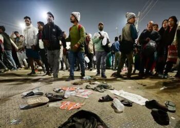 Pilgrims look for their belongings at the site of a stampede amid the ongoing Maha Kumbh Mela festival in Prayagraj.